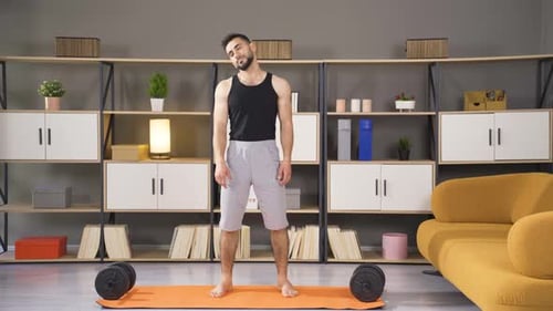 Young athlete doing warm-up and stretching movements, head and neck area.