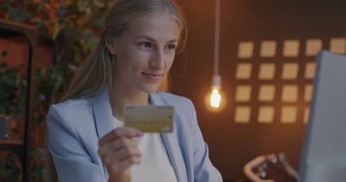 Woman Shopping Online with Credit Card at Desk