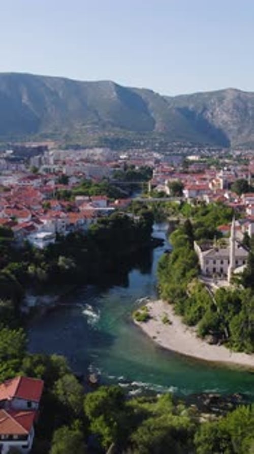Neretva River flowing through Mostar in Bosnia and Herzegovina. Aerial, Vertical Video