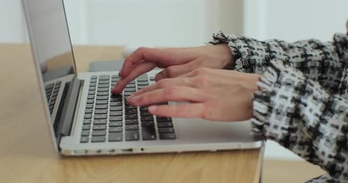 Close Up Young Female Hands Typing Message on Laptop Keyboard
