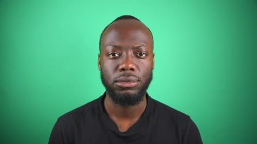 Black Male Staring To Camera With Blank Face With Green Screen Background