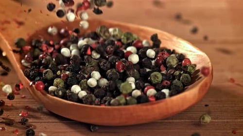 Colorful Peppercorns Filling a Wooden Spoon
