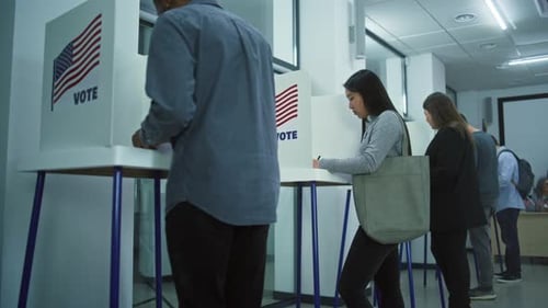 Diverse Citizens Come to Vote in Booths in Polling Station Office