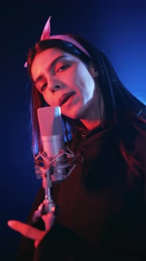 Young Female Singer Performing in Recording Studio