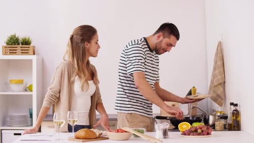 Couple Cooking Meal Together in Home Kitchen
