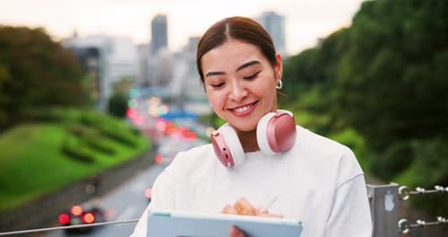 Woman Using Tablet Device on City Overpass