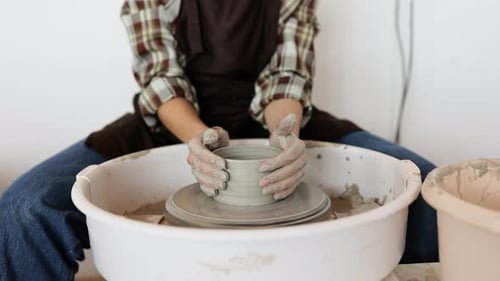 Woman Making Pottery on a Pottery Wheel
