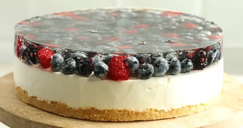 Berry Topped Cheesecake Dessert on Wooden Board