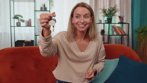 Woman Real Estate Agent Showing the Keys of New Home House Apartment Buying or Renting Property