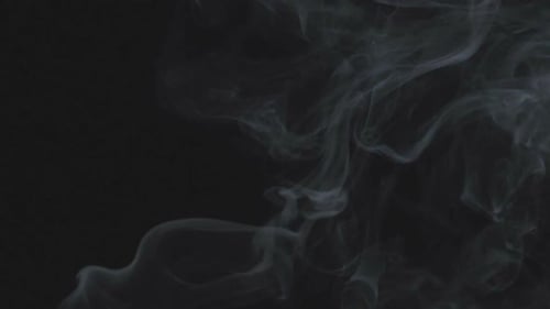 Wispy White Smoke Flowing on Black Background