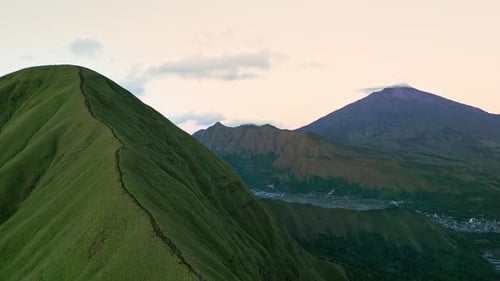Scenic Lombok Highlands with Grassy Ridgeline and Mount Rinjani Backdrop Aerial Footage