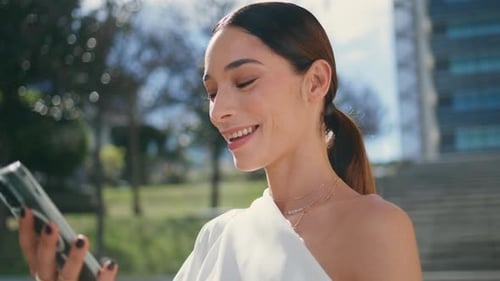 Happy Brunette Looking Telephone Browsing Social Media Outdoors Close Up