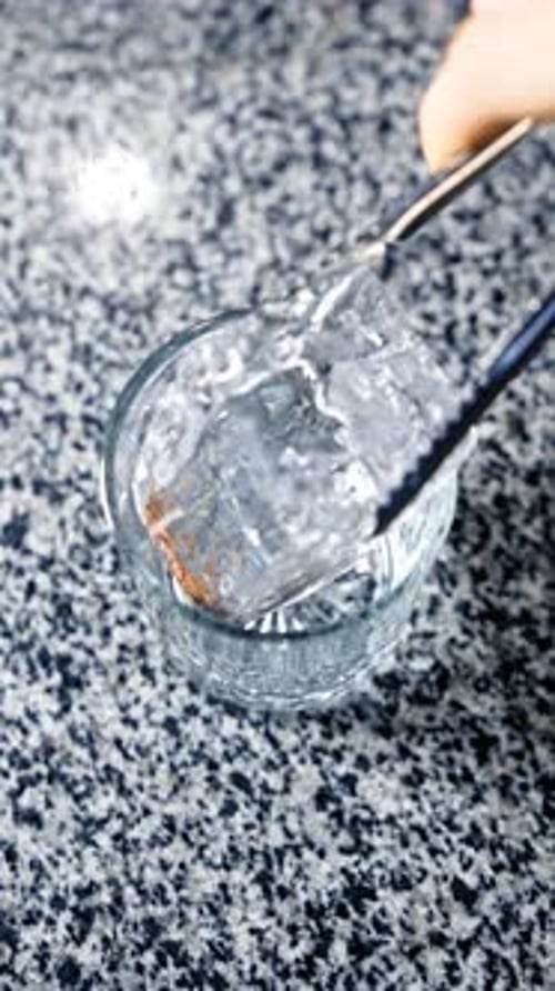 Ice Cubes Placed Into Glass with Tongs