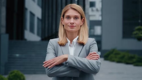 Businesswoman in Suit Smiling at Camera Outside Office