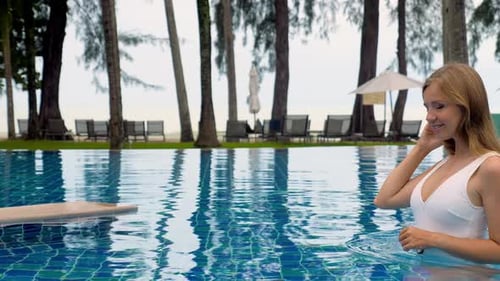 Travel Vacation Woman Relaxing Sunbathing in Bikini on Resort Pool