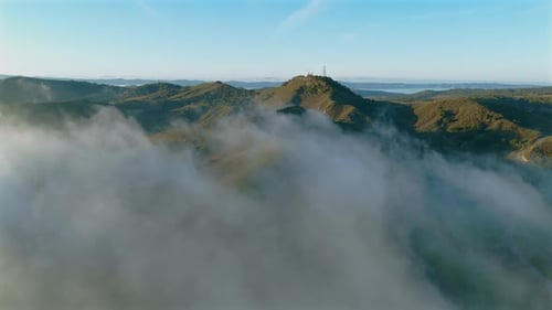 The Serene Mountain Landscape Emerges Beautifully From the Enveloping Morning Fog