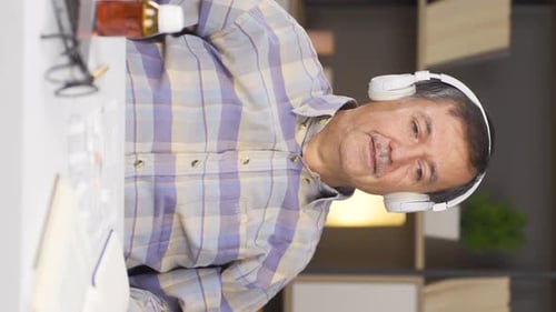 Man with Headphones Listening to Music at Home