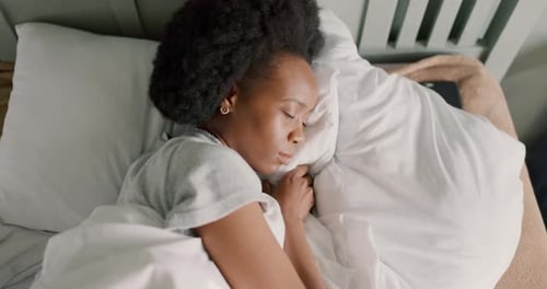 Bedroom, insomnia and girl with sleep problem or mental health difficulty trying to rest in home
