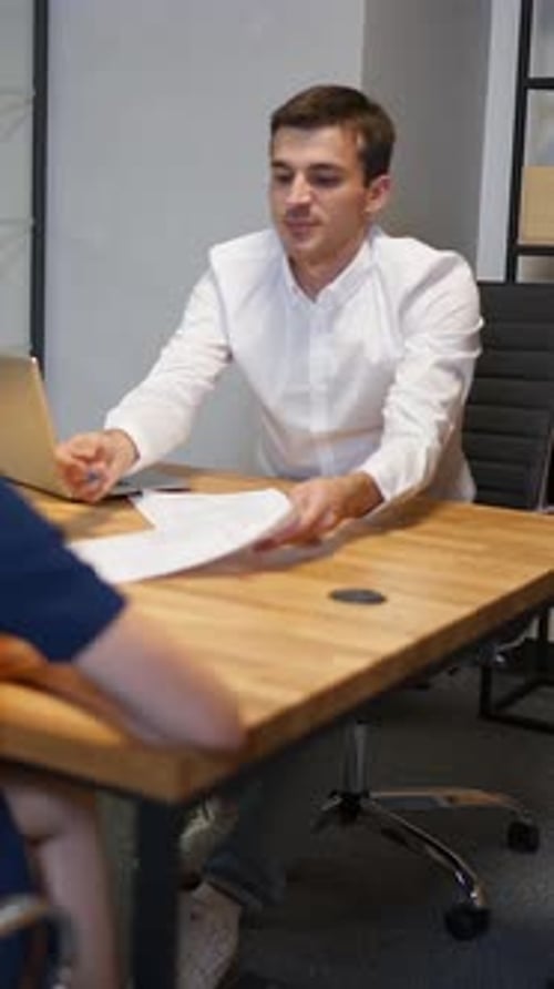 Vertical of Family and Realtor Businessman in Boardroom Discussing About Mortgage Contract