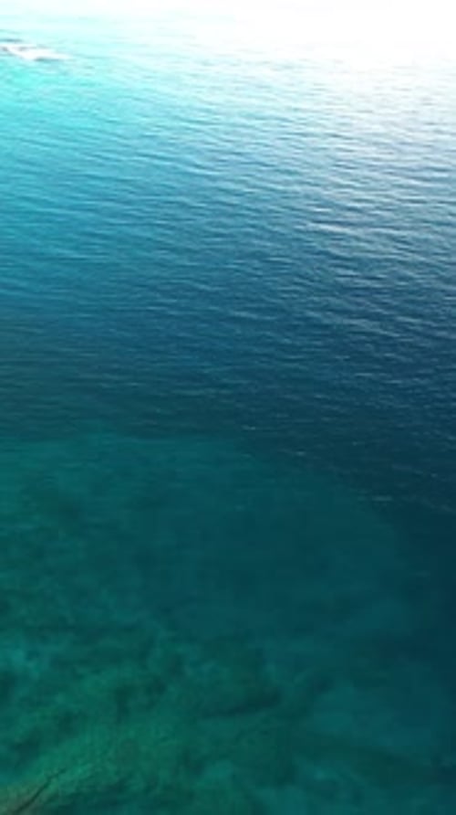 Aerial vertical view of serene turquoise waters near Captain Cook in Hawaii