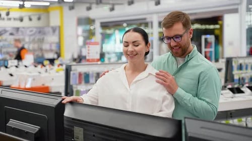 Young Couple Buying New Tv at Tech Store for New Home