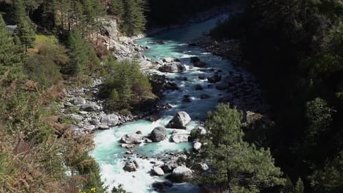 A high angle view of a river flowing with glacial water in the Himalaya Mountains of Nepal.