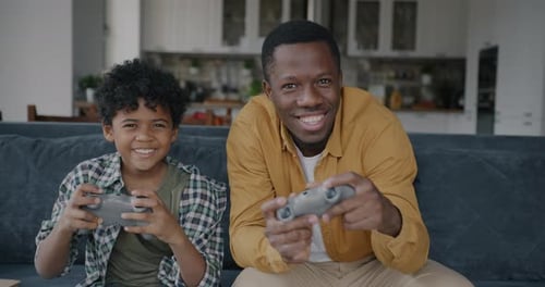 Father and Son Playing Video Games at Home