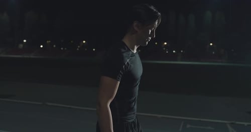 Cinematic close up shot of young disabled man with legs prosthesis prepares for launching off the