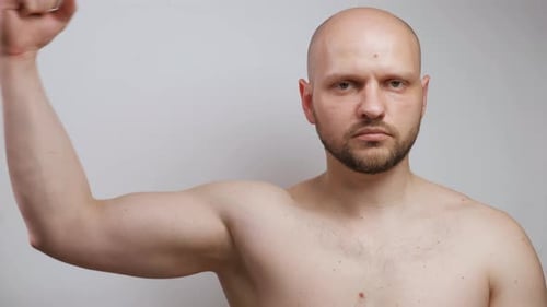 Shirtless Man Flexing Bicep Muscles