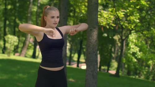 Attractive Female Runner Stretching in Summer Park. Fit Girl Doing Stretching Exercise