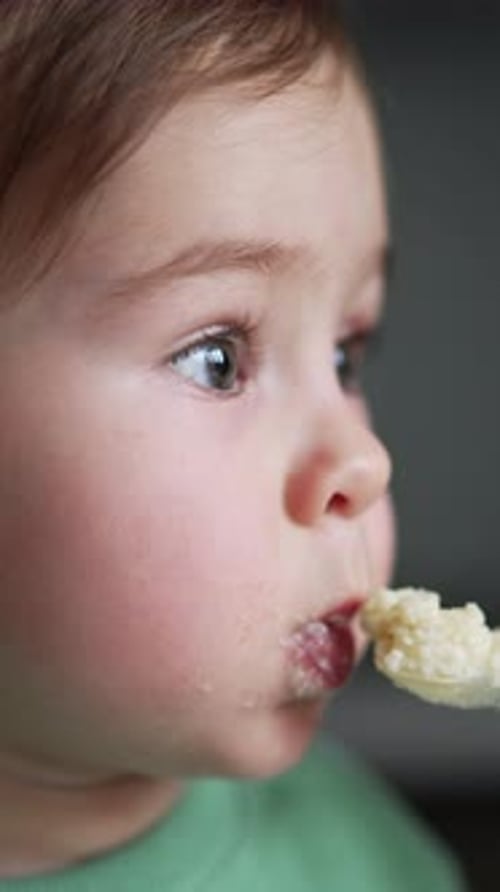 Delightful Close-Up of Sweet Infant Eating Indoors
