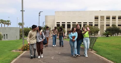 Young Group of Friends Having Fun Outside with School Building on Background Background