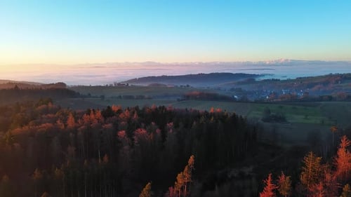 Mountain Valley with Pine Forest Fields and Villages Overlooking the Snowcapped Alpine Mountains