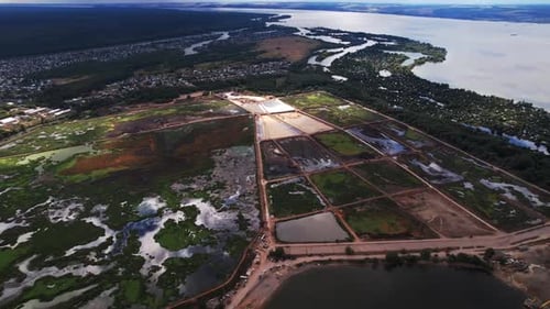 Silt Production Fields Separated By Mounds on Riverbank