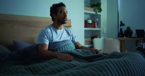 Man Sitting in Bed at Night, Awake