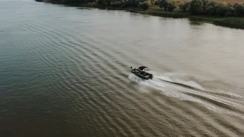 A fishing boat is sailing on the river. A fishing boat is walking on the water.