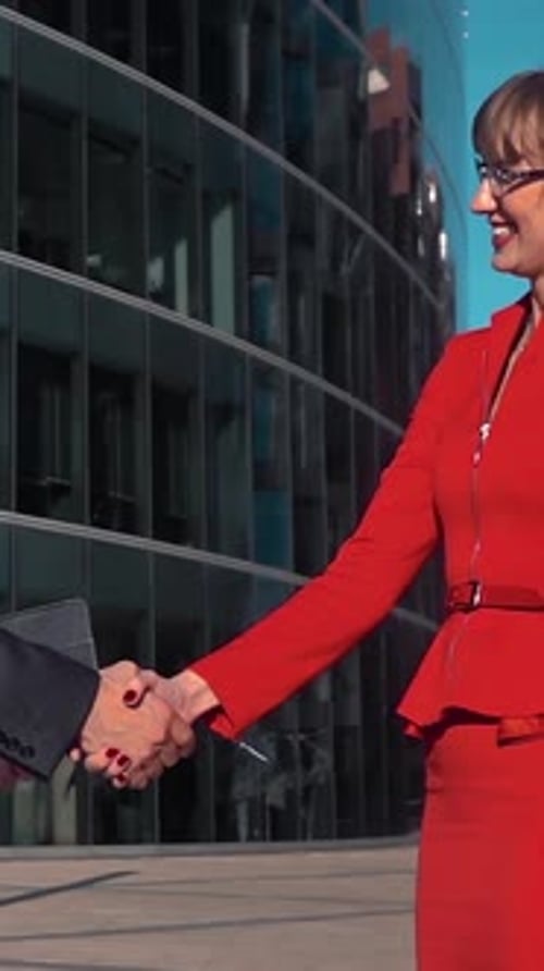 Business People Shaking Hands in Front of Office Building