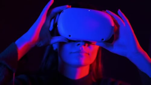 Woman Using VR Headset in Dark Room