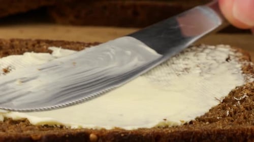Spreading Butter on Brown Bread Close Up