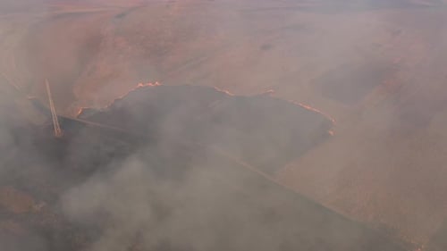 Aerial View of Spring Dry Grass Burning field. Fire and Smoke in the Meadow, Nature Pollution