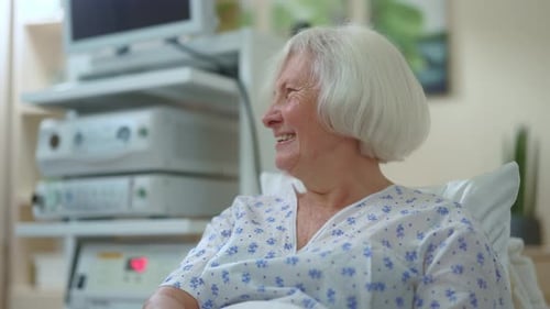 Senior Woman Smiling in Hospital Bed, Close Up