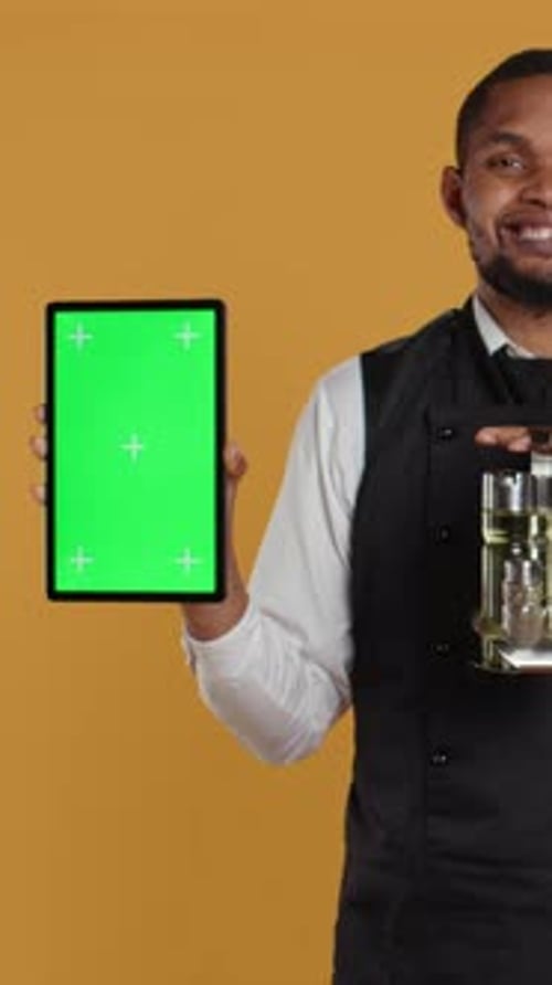 Man Holds Tablet With Green Screen Smiling