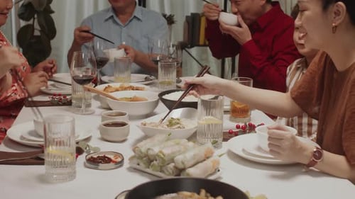 Family Gathered Around Table Eating Meal