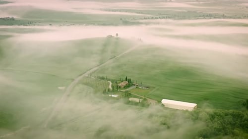 Flying over the foggy Tuscany Italy landscape