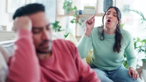 Couple Arguing on Sofa in Brightly Lit Home