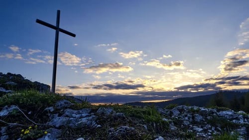 Christian Cross on a Rock at Sunset Colorful Clouds in the Blue Sky Timelapse