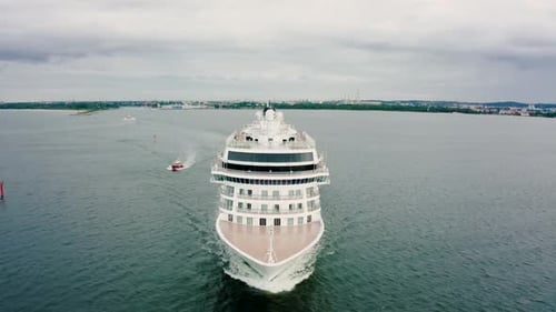 Aerial View of a Luxury Cruise Ship Sailing From the Port at Sunset