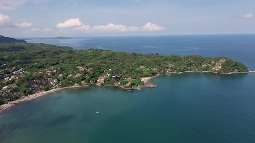 Tropical Coastal Town with Sailboat Aerial View