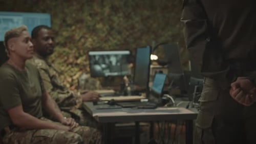 Military Officer Walking with Hands Locked behind His Back along Office