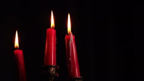 Three Red Candles Burning in the Darkness